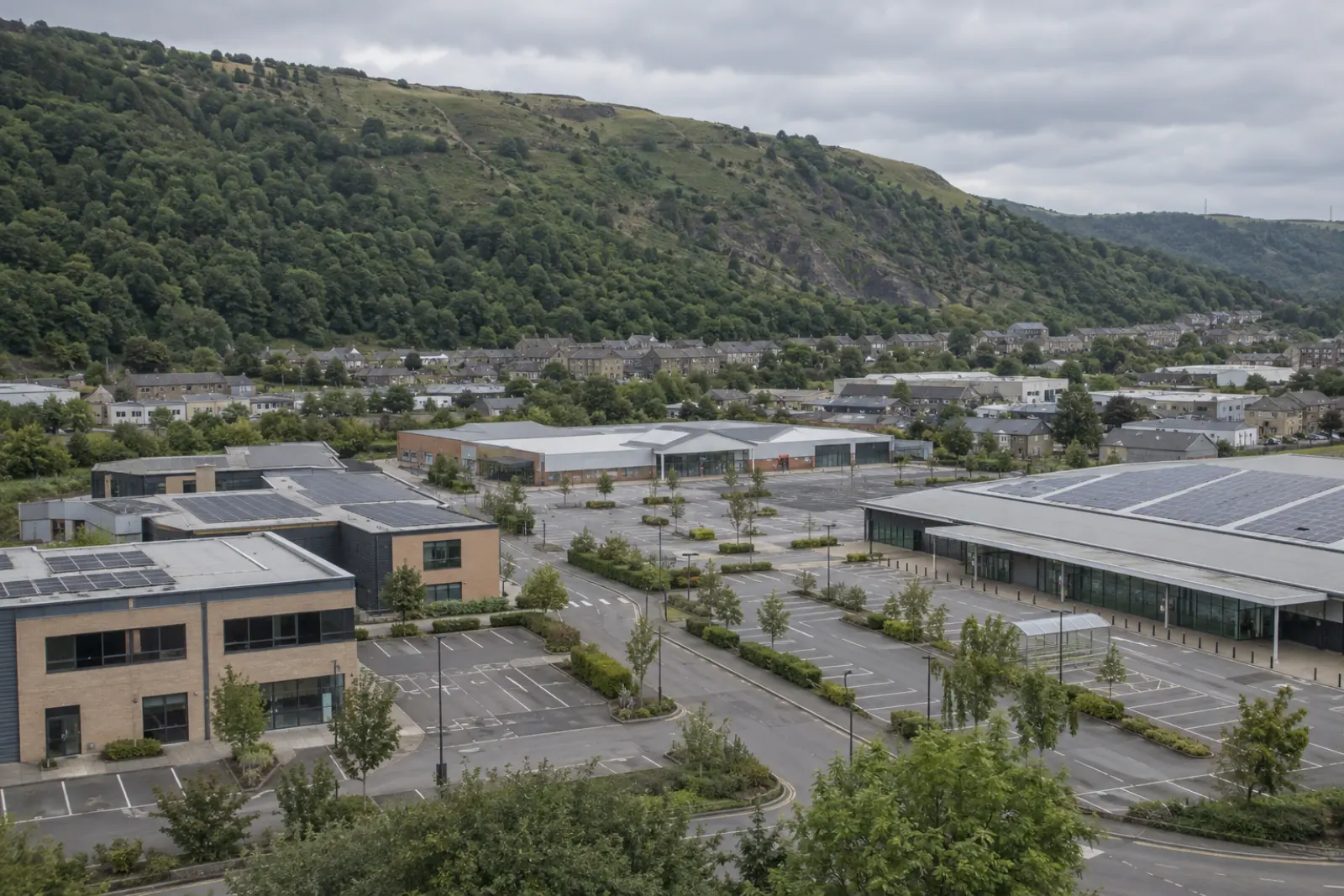 The commercial edge of a South Wales valley town, several roofs carrying solar